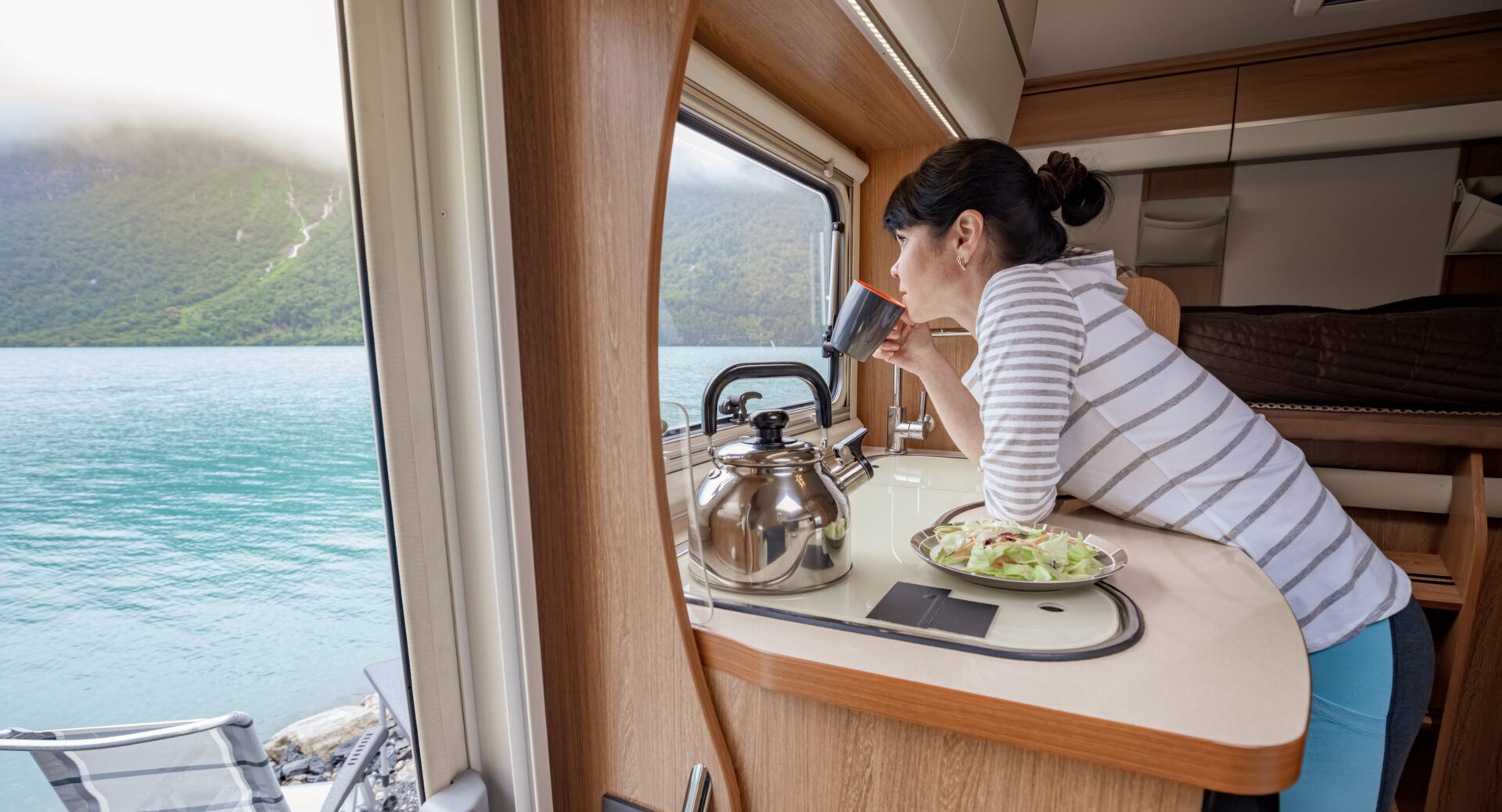 Woman,In,The,Interior,Of,A,Camper,Rv,Motorhome,With