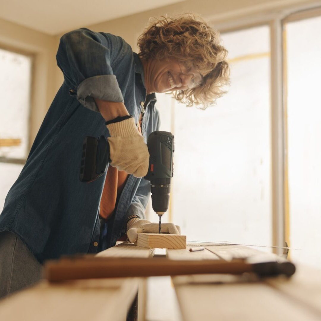 Caucasian,Woman,Happily,Renovates,Her,Kitchen,,Using,Hand,Tools,And